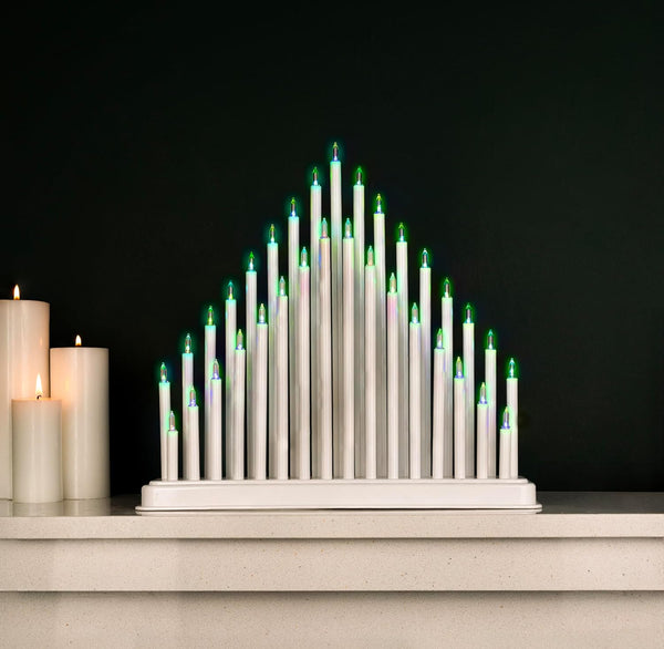Modern candle arrangement with green flames on a dark background