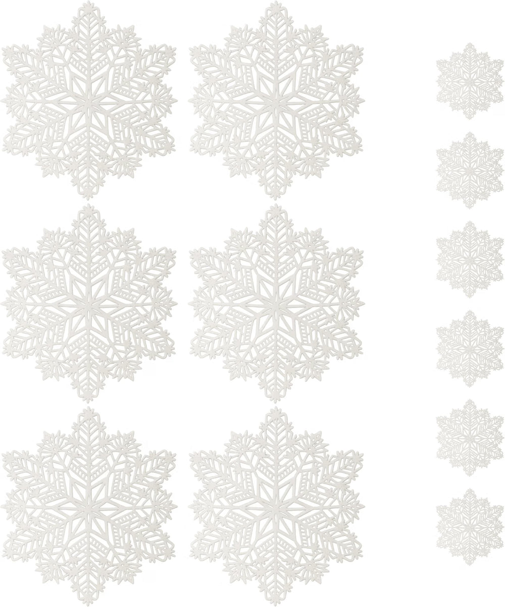 White snowflake-shaped table placemats arranged on a white tablecloth, with a fork and knife placed beside them.