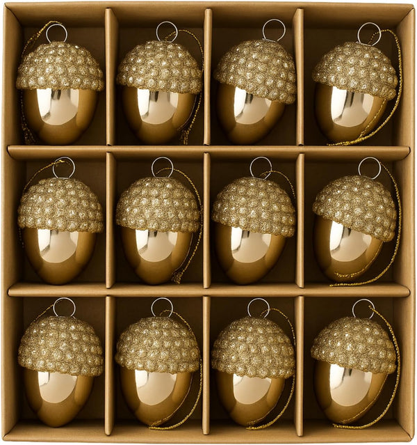 Gold acorn-shaped ornaments with beaded tops in a cardboard box.
