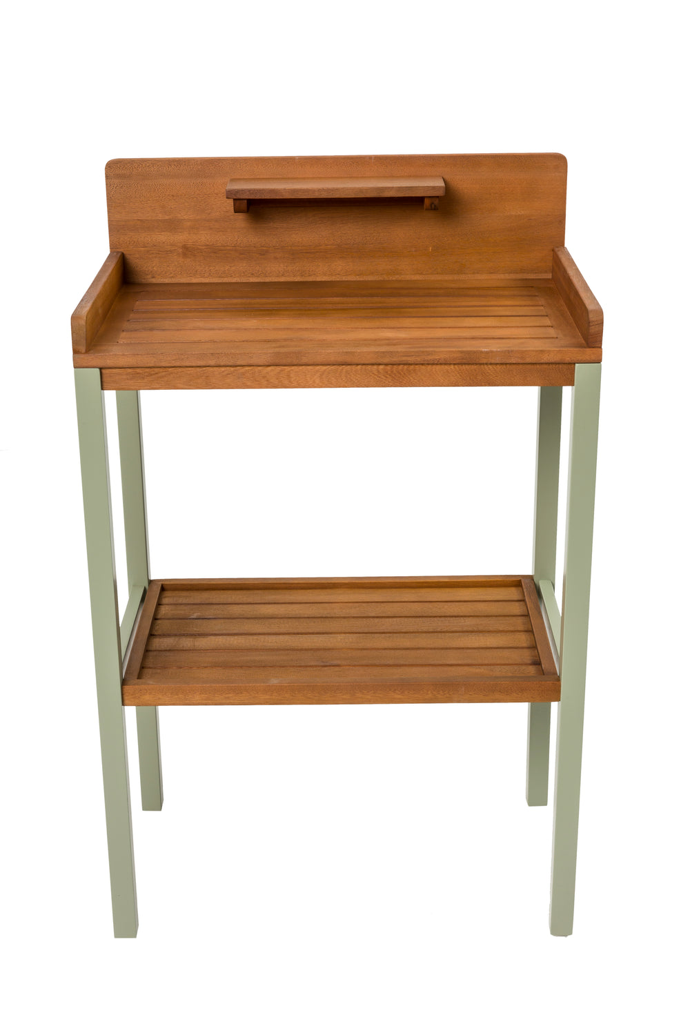 Gardening station with plants, tools, and boots against a brick wall.