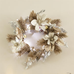 Decorative wreath with gold and silver elements on a beige background