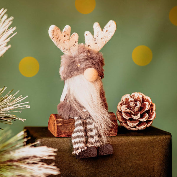 Decorative gnome with reindeer antlers on a green background