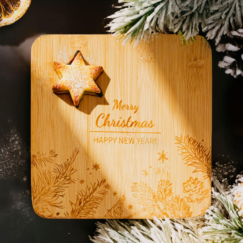 Wooden cutting board with Christmas decorations and a star-shaped cookie.