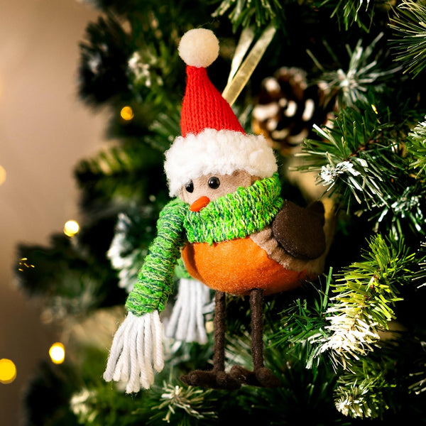 Decorative bird ornament with a Santa hat on a Christmas tree