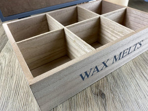 Wooden box labeled 'Wax Melts' on a wooden surface