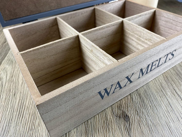 Wooden box labeled 'Wax Melts' on a wooden surface