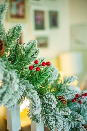 Artificial Christmas greenery with snowy branches and pinecones
