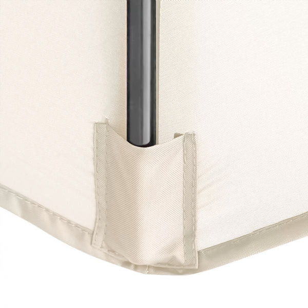 Close-up of a cream-colored fabric corner with a black metal support pole inserted into a reinforced fabric sleeve.