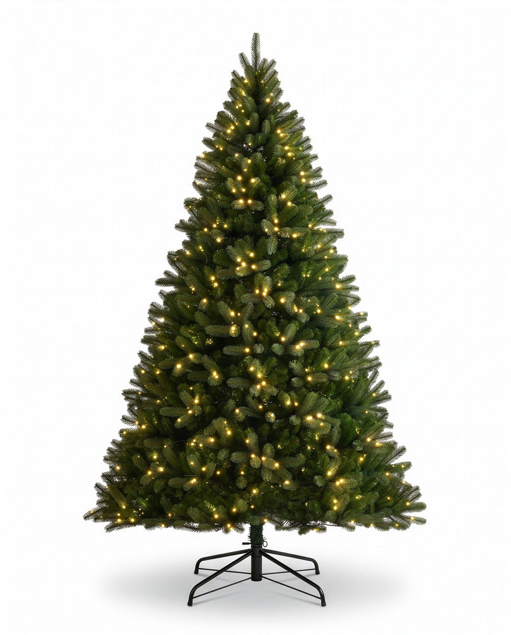 A tall artificial Christmas tree with warm white lights, displayed in a cozy living room next to a fireplace and window.