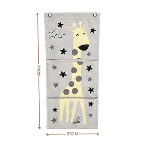 A three-panel fabric wall hanging with a cartoon giraffe and star pattern, shown with dimension arrows and labels indicating 74CM height and 29CM width on a white background.