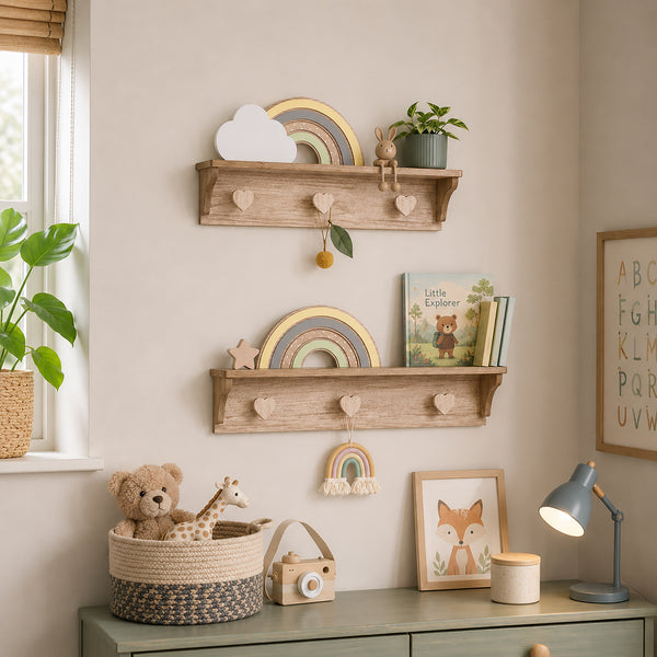A styled children's room corner with two rustic wooden floating shelves mounted on a beige wall. The shelves hold a small potted plant, a cloud-shaped decor piece, a rainbow decoration, a star, and children's books.
