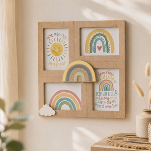 A light natural wood four-frame wall art display mounted on a beige wall, featuring pastel rainbow and sun illustrations with handwritten-style text. A small white cloud cutout is tucked into the lower left frame.