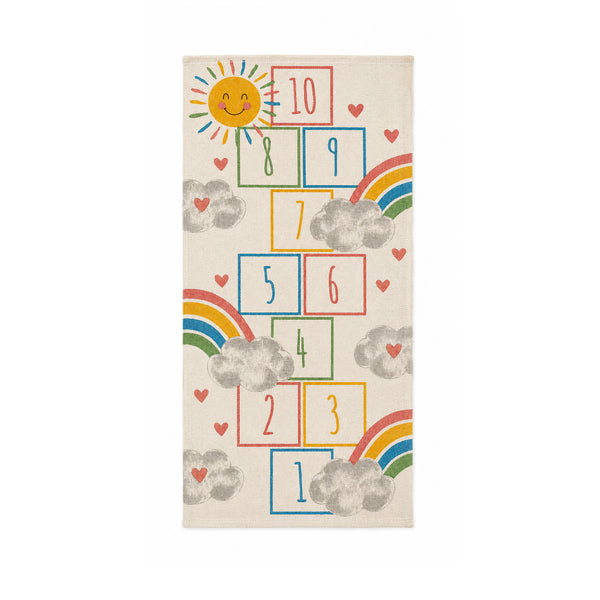 A rectangular cream-colored rug featuring a colorful hopscotch game design with a smiling sun, rainbows, clouds, and hearts.