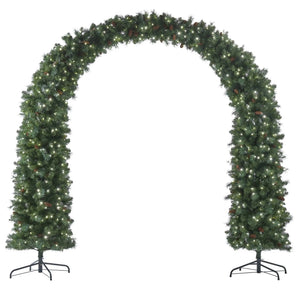 A green artificial Christmas tree arch with warm white string lights and small pinecones, displayed on a black metal stand against a white background.