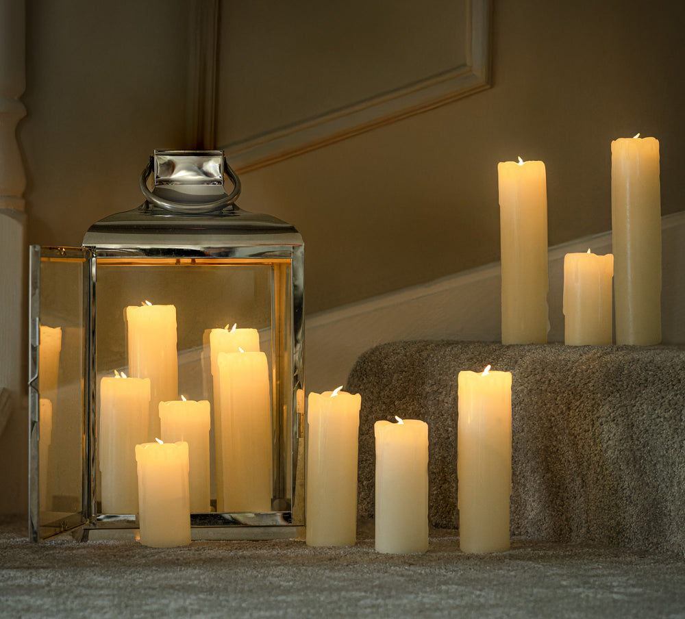 12 LED flameless candles which vary in size placed on a staircase