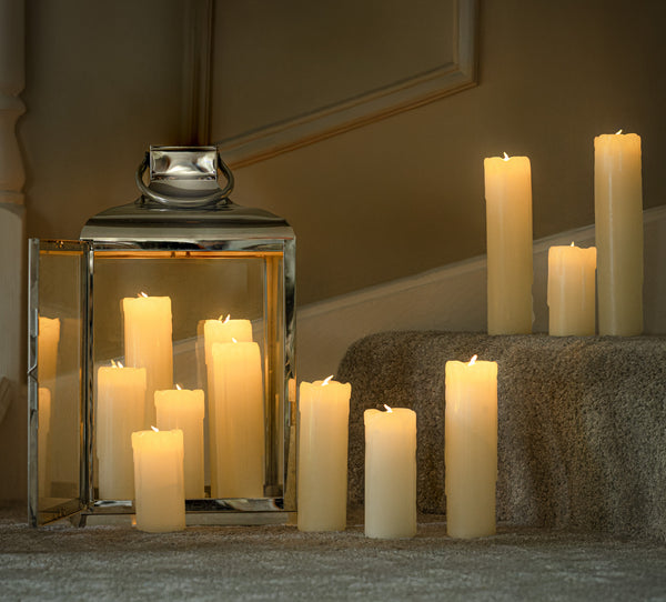 12 LED flameless candles which vary in size placed on a staircase