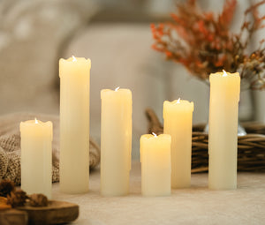 Five lit candles on a surface with a blurred background