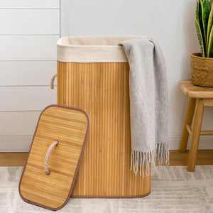 Bamboo laundry basket with a gray towel draped over it in a room setting.