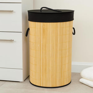 Wooden laundry basket with a black lid in a room setting