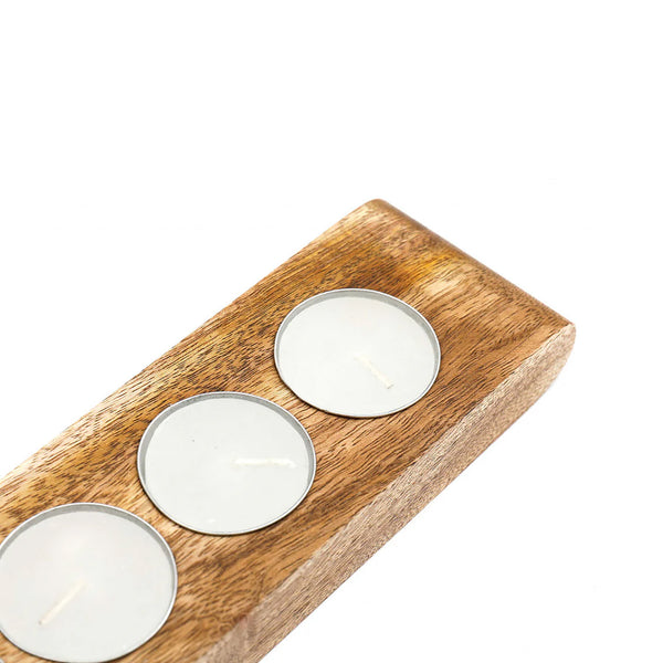 A rectangular wooden candle holder with a warm medium-brown grain, featuring three recessed circular holders containing white tea light candles, shown against a plain white background.