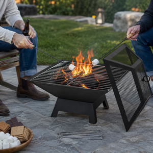 People roasting marshmallows over a fire pit in a backyard setting.