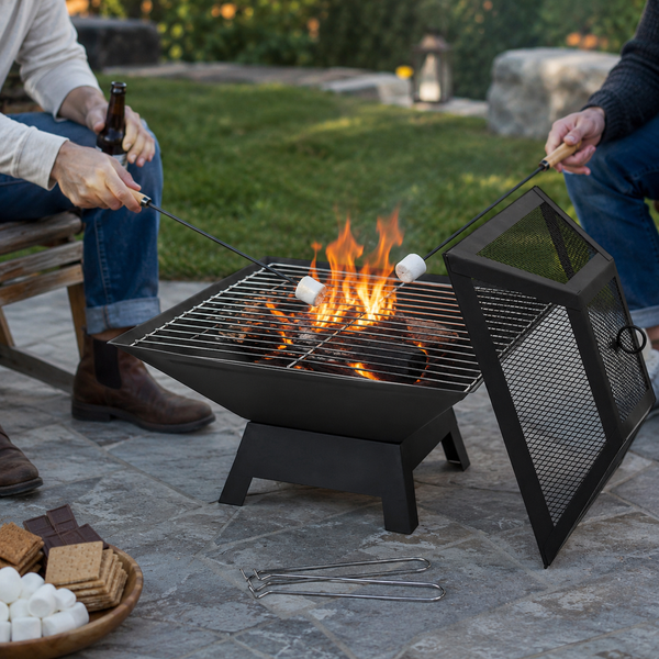 People roasting marshmallows over a fire pit in a backyard setting.