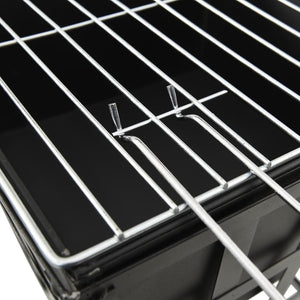 Close-up of a metal grill rack on a black background