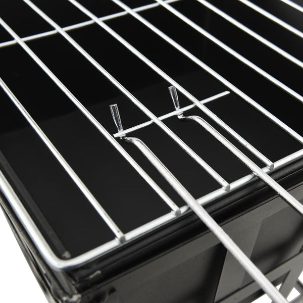 Close-up of a metal grill rack on a black background