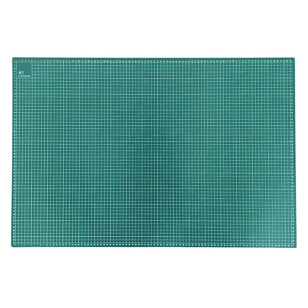 A rectangular green cutting mat with a white grid pattern and a dotted border, shown flat against a white background.
