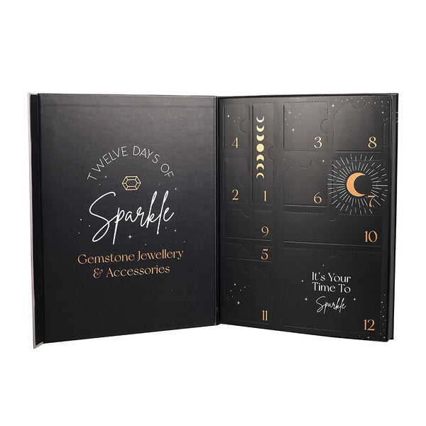 Open black advent calendar with gold text and designs, featuring 'Twelve Days of Sparkle' jewellery and accessories theme.