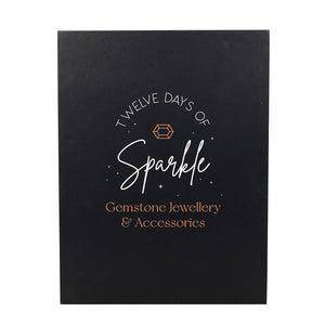 Black packaging with 'Twelve Days of Sparkle' text and gemstone jewellery branding.