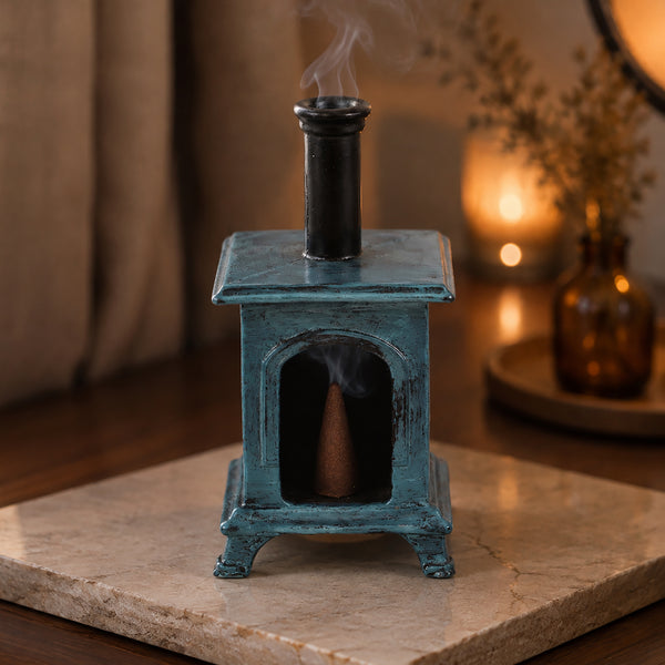 stove shaped incense cone burner in a warm tone interior setting

