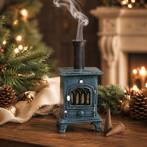 festive christmas scene with main focus on a blue stove and smoke coming out of its chimney
