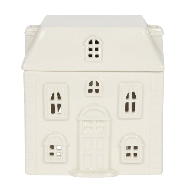 An off-white ceramic house-shaped container or ornament with detailed window cutouts and a central door, shown on a plain white background.