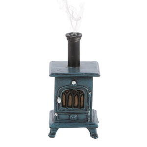 Decorative miniature wood stove with smoke on a white background