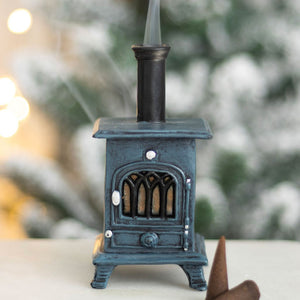 Decorative miniature stove with a blurred snowy background