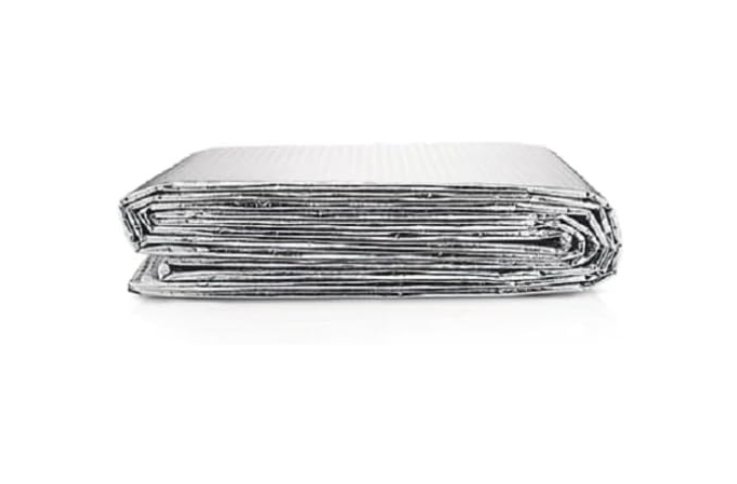 Folded metallic blanket on a white background