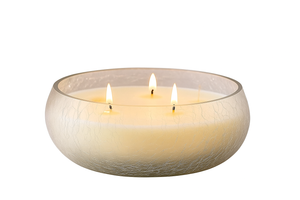 Three-wick candle in a glass bowl on a white background