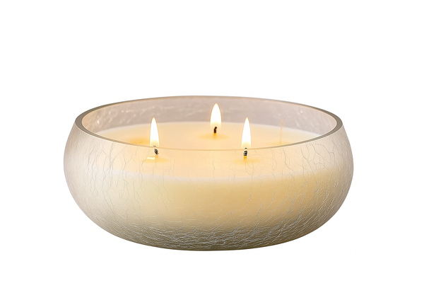 Three-wick candle in a glass bowl on a white background