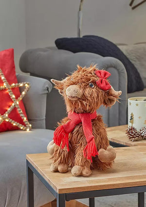 Soft Highland cow decoration displayed on a mantelpiece