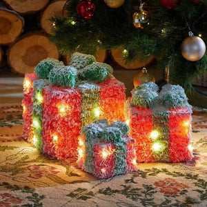 Red and green illuminated Christmas boxes displayed together