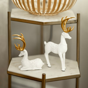 Sitting cement reindeer decoration shown from the front