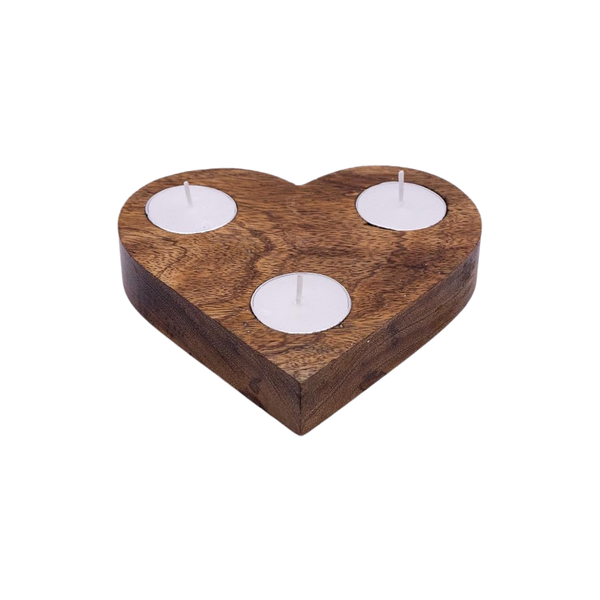 A heart-shaped wooden candle holder with a natural brown wood grain finish, featuring three circular recesses holding small white tea light candles, shown on a plain white background.