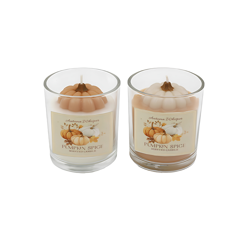 Two lit 'Pumpkin Spice' scented candles in clear glass jars with white pumpkin toppers, displayed on a wooden tray in a cozy, warm autumn-themed living room setting.