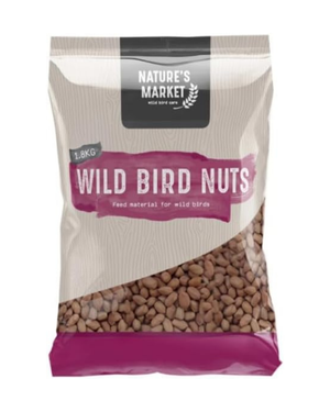 A 1.8kg bag of Nature's Market Wild Bird Nuts food material for wild birds, featuring a beige and magenta design with a clear window showing the brown nuts inside.