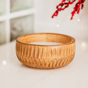 wooden candle on a white surface with a blurred background