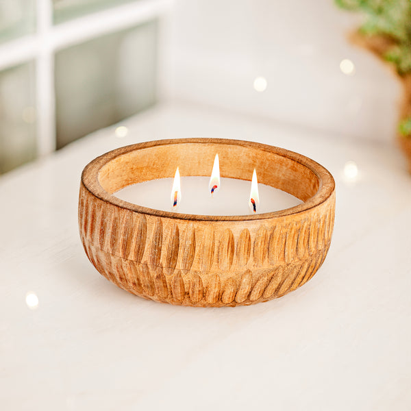 Wooden Candle on white table with glistening lights