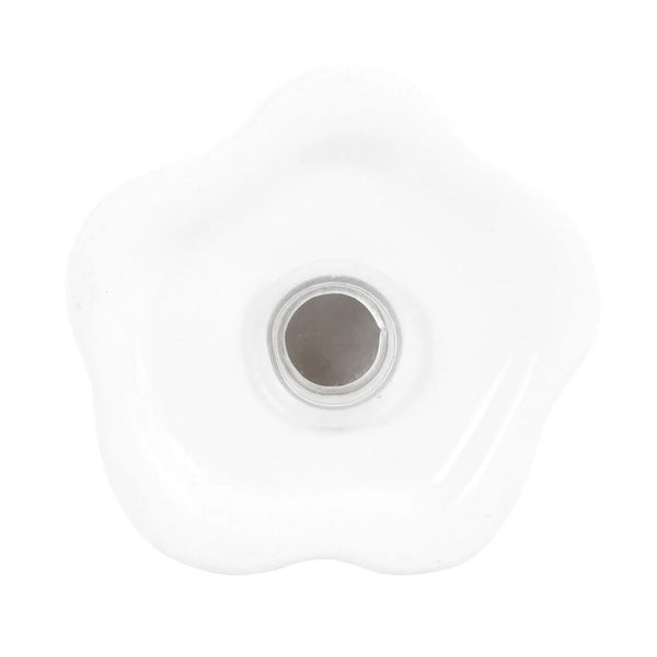 A white ceramic knob with a scalloped, flower-like edge and a circular metallic center, shown on a plain white background.