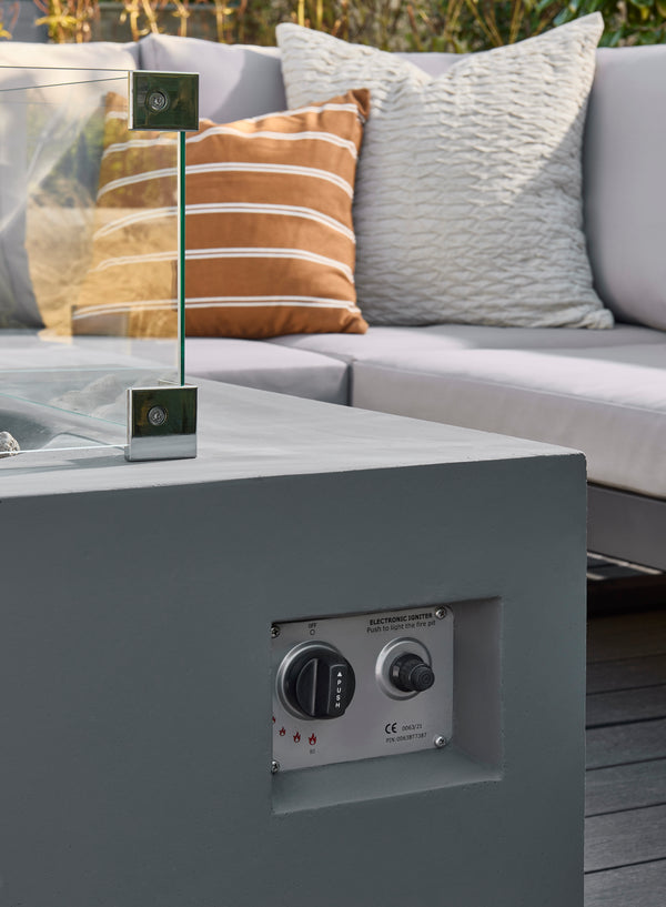 Outdoor furniture set with a gray table and cushions on a wooden deck.