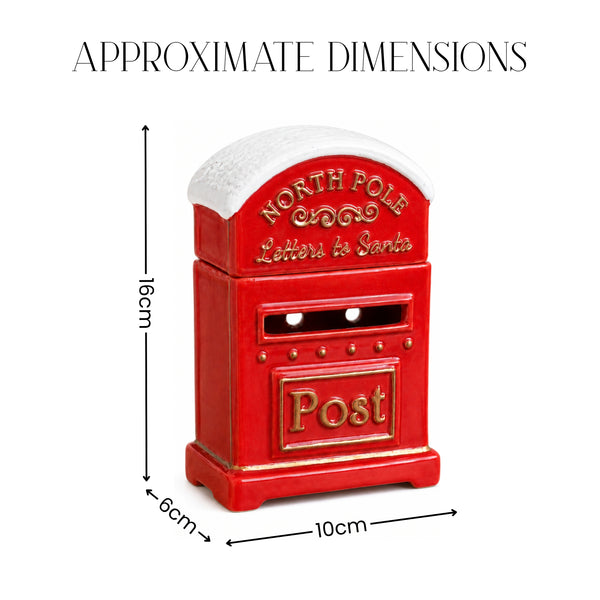 A red post box shaped like the North Pole letter box with gold lettering and a white snowy roof, shown with dimension arrows and labels reading 16cm height, 6cm width, and 10cm depth on a white background.
